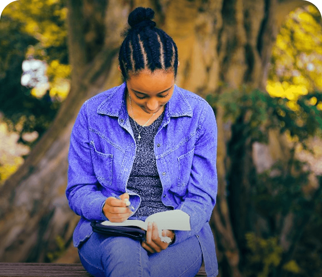 Author writing notes outdoors