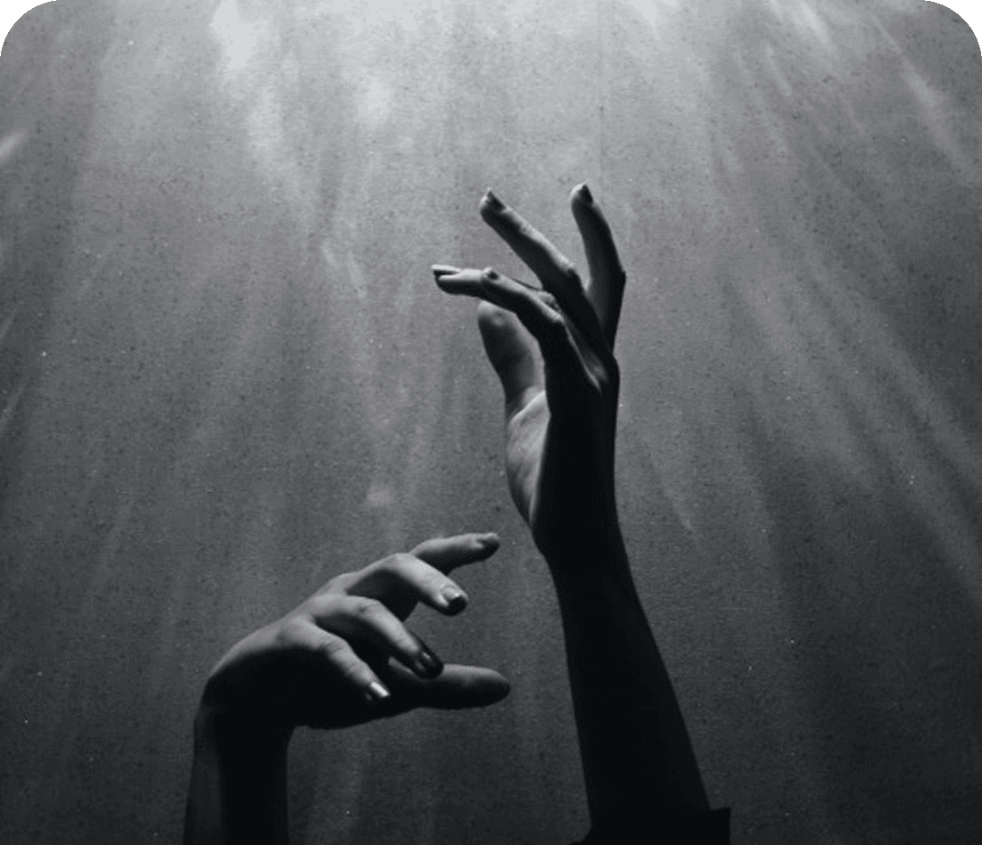 Hands reaching toward light